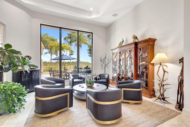 interior space featuring visible vents, baseboards, a tray ceiling, recessed lighting, and a towering ceiling