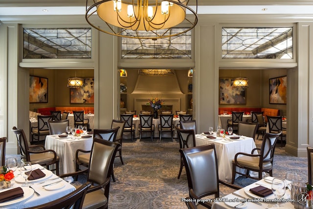 dining room featuring a notable chandelier and a high ceiling