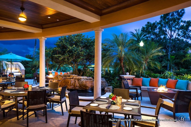 view of patio / terrace with outdoor dining area and a fire pit