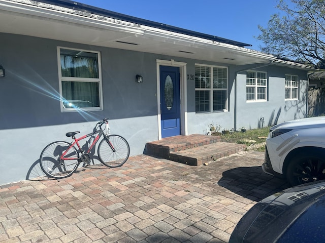 property entrance with stucco siding