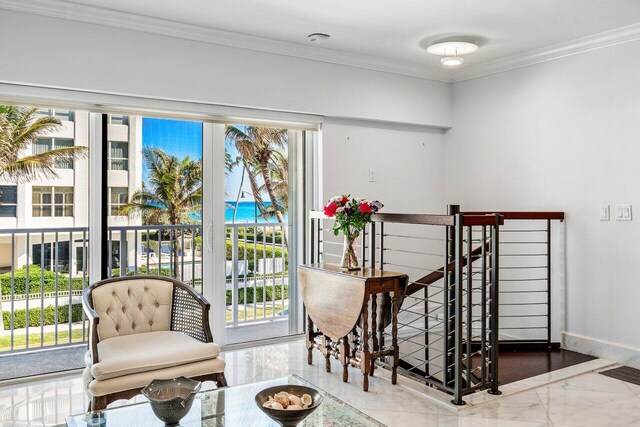 interior space featuring an upstairs landing, marble finish floor, baseboards, and ornamental molding