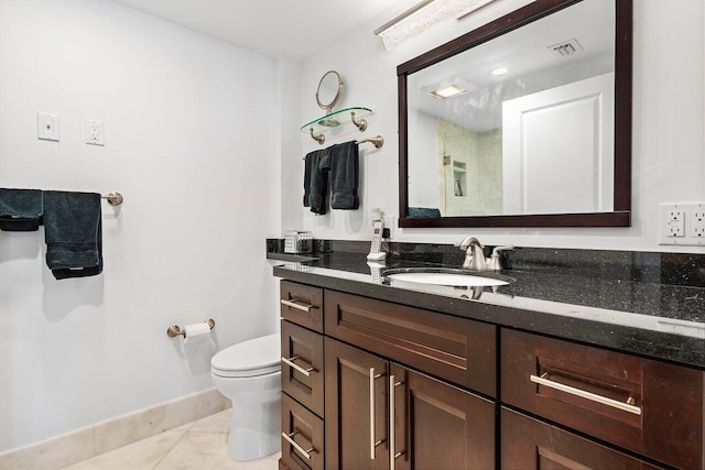 bathroom featuring vanity, baseboards, visible vents, tile patterned floors, and toilet