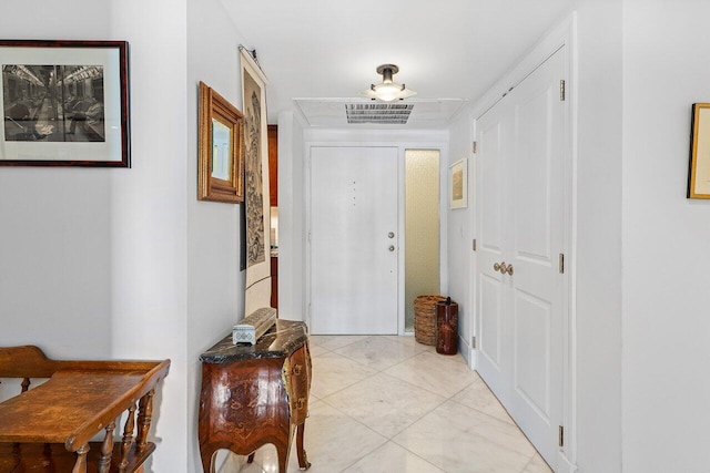 entrance foyer featuring light tile patterned floors and visible vents