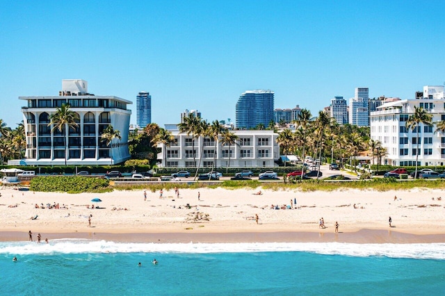 exterior space with a city view, a view of the beach, and a water view