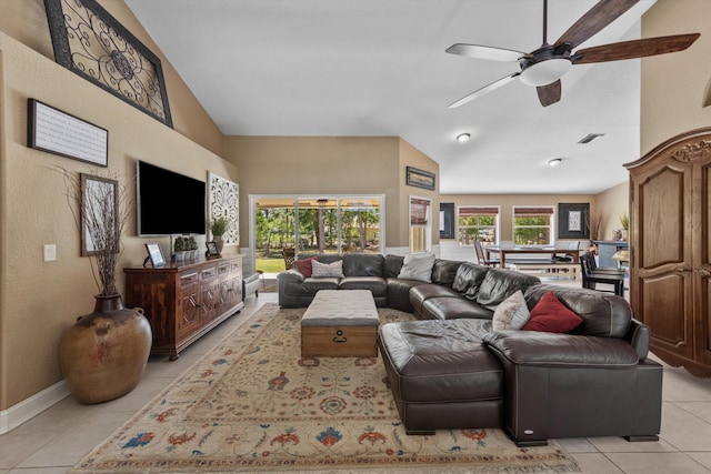 living room with visible vents, baseboards, ceiling fan, light tile patterned floors, and high vaulted ceiling