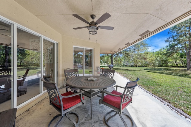 view of patio featuring outdoor dining area and a ceiling fan