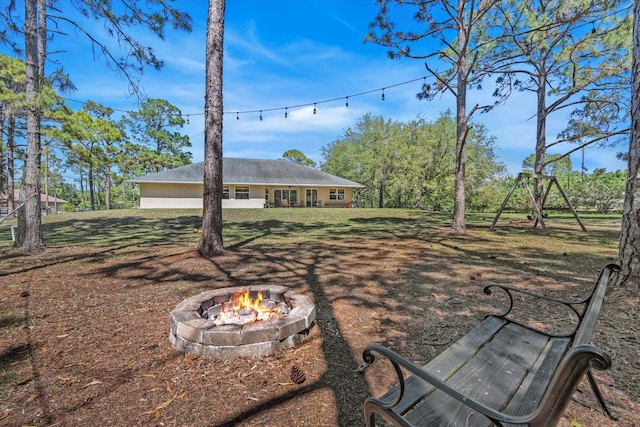 view of yard with an outdoor fire pit