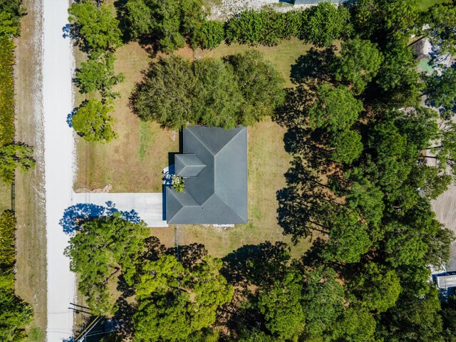 birds eye view of property with a view of trees