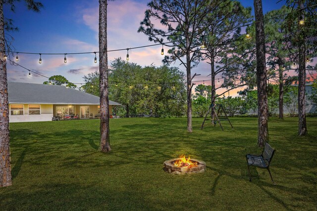view of front of property with a yard, an attached garage, fence, and concrete driveway