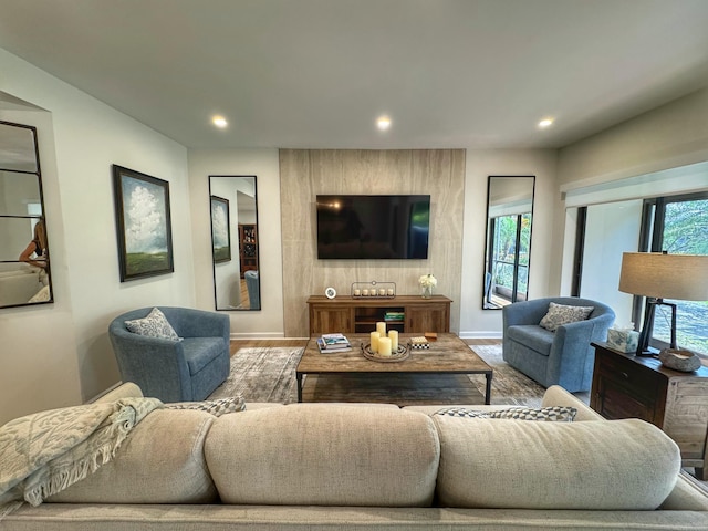 living room with recessed lighting, baseboards, and a wealth of natural light