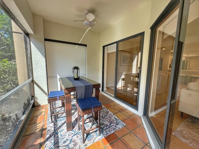 sunroom / solarium with a ceiling fan