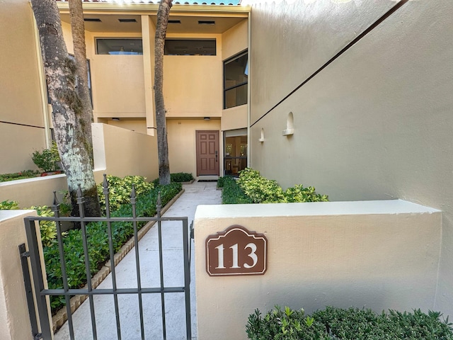 property entrance with stucco siding