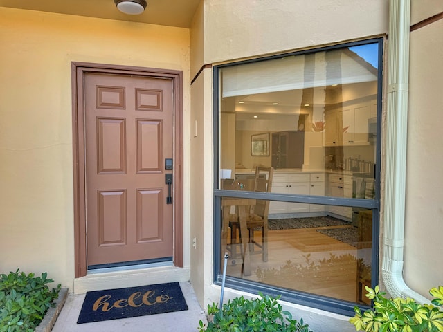 entrance to property featuring stucco siding