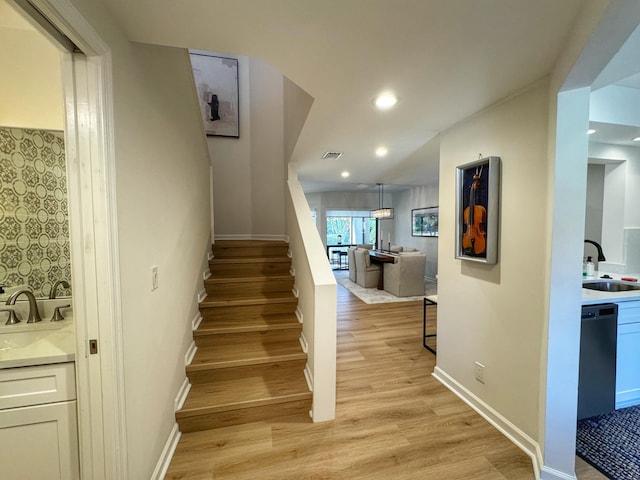 stairs featuring recessed lighting, visible vents, baseboards, and wood finished floors