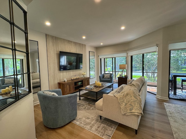 living room featuring recessed lighting, wood finished floors, and baseboards