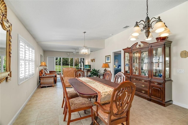 dining room with light tile patterned floors, visible vents, lofted ceiling, a textured ceiling, and a chandelier