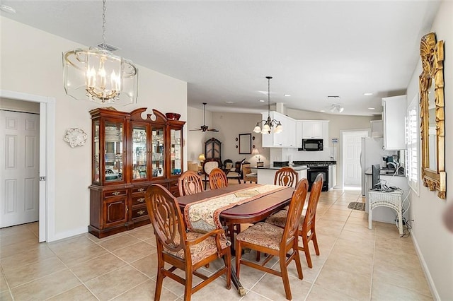 dining area with light tile patterned floors, baseboards, and a notable chandelier