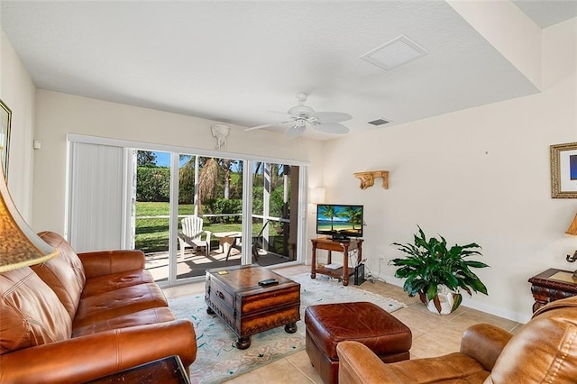 living area with light tile patterned flooring, baseboards, visible vents, and ceiling fan