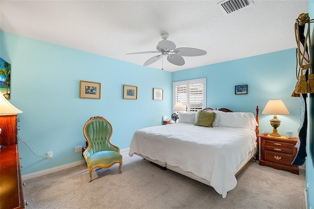 bedroom featuring visible vents, baseboards, a textured ceiling, and carpet flooring