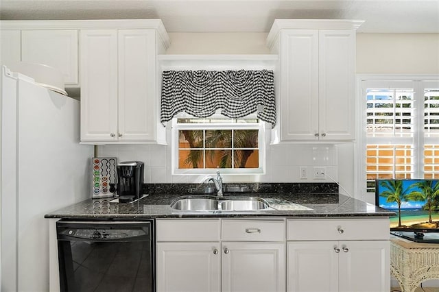 kitchen with dishwasher, white cabinetry, and a sink