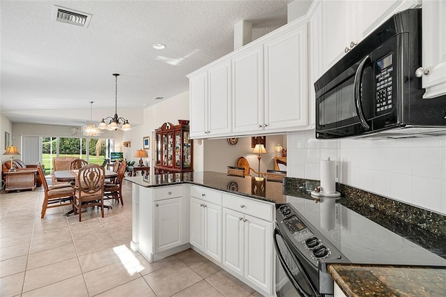 kitchen featuring light tile patterned floors, visible vents, black appliances, and a peninsula