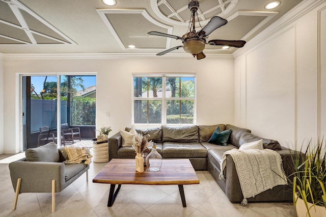 living room featuring crown molding, plenty of natural light, coffered ceiling, and ceiling fan