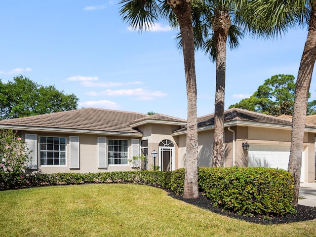 ranch-style home with a front yard, an attached garage, concrete driveway, and stucco siding