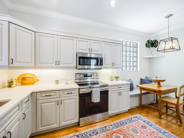 kitchen featuring light wood-style flooring, tasteful backsplash, appliances with stainless steel finishes, and ornamental molding