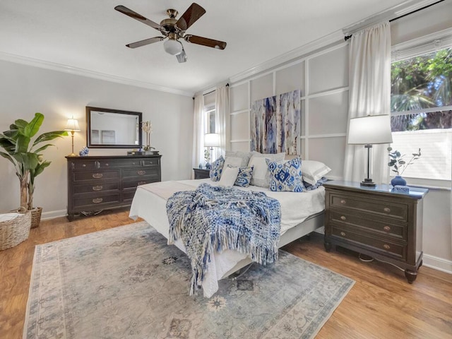 bedroom featuring multiple windows, wood finished floors, and ornamental molding