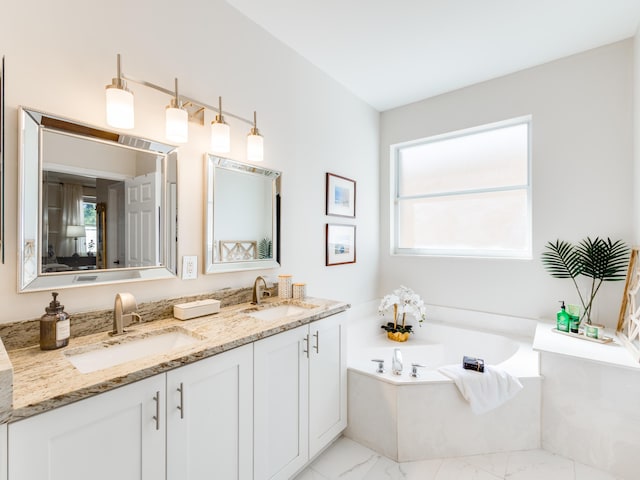 bathroom with plenty of natural light, marble finish floor, and a sink