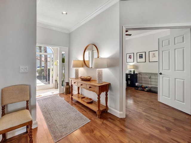 entrance foyer featuring recessed lighting, wood finished floors, baseboards, and ornamental molding