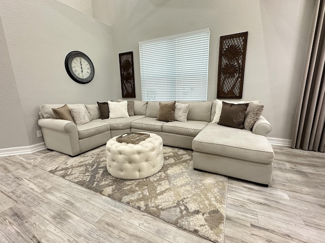 living room featuring wood finished floors and baseboards