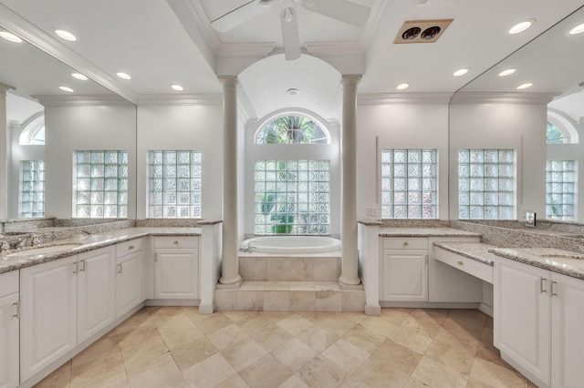 bathroom with a sink, a bath, ornamental molding, and ornate columns