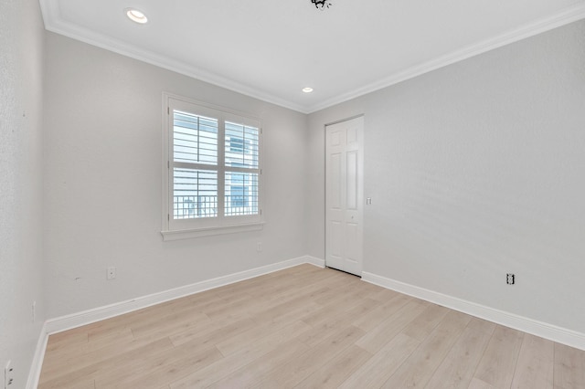 unfurnished room featuring recessed lighting, light wood-style flooring, crown molding, and baseboards