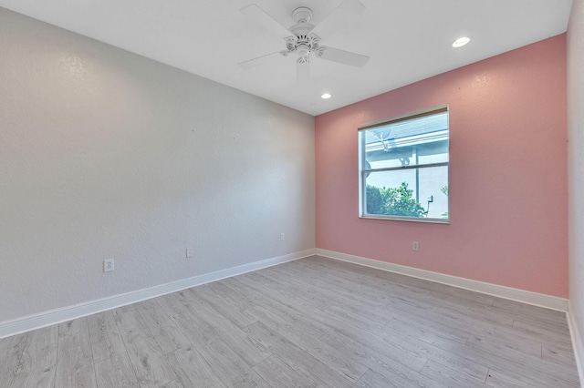 spare room featuring light wood finished floors, recessed lighting, a ceiling fan, and baseboards