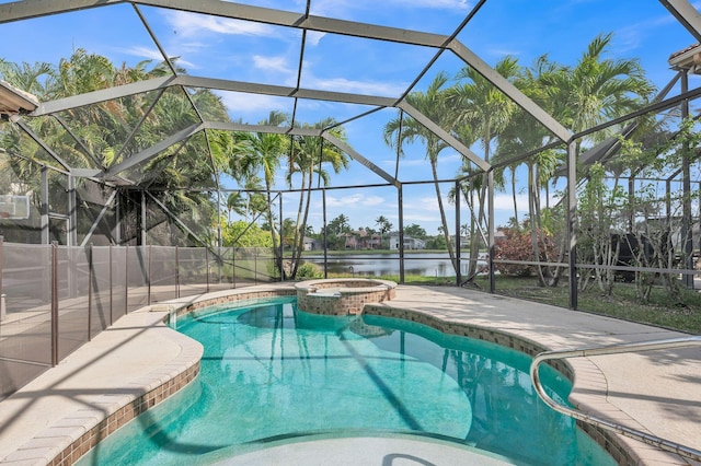 view of swimming pool with glass enclosure, a pool with connected hot tub, a patio, and a water view