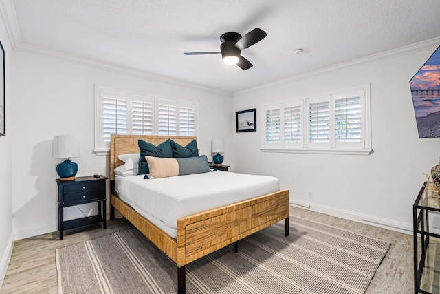 bedroom with multiple windows, wood finished floors, and ornamental molding