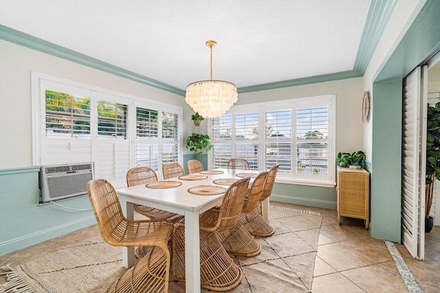 dining room with an AC wall unit, an inviting chandelier, crown molding, light tile patterned floors, and baseboards