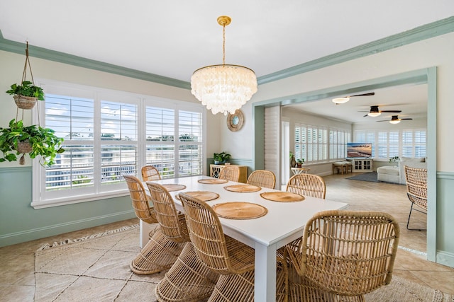 dining space with light tile patterned floors, ceiling fan with notable chandelier, baseboards, and ornamental molding