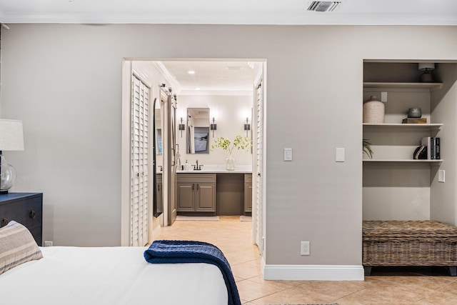 bedroom featuring visible vents, a sink, crown molding, light tile patterned floors, and baseboards