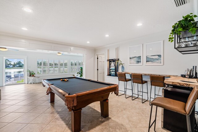 recreation room with light tile patterned flooring, visible vents, plenty of natural light, and crown molding