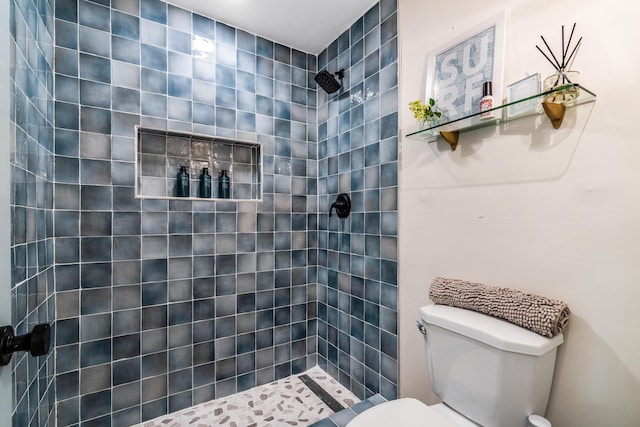 bathroom featuring toilet and tiled shower