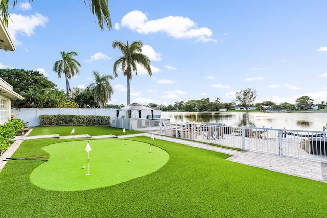 exterior space featuring a gazebo, a fenced backyard, a water view, and a patio area