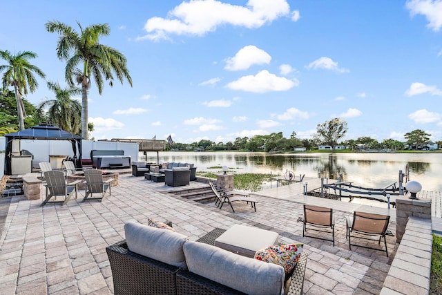 view of patio / terrace featuring a gazebo, an outdoor living space with a fire pit, and a water view