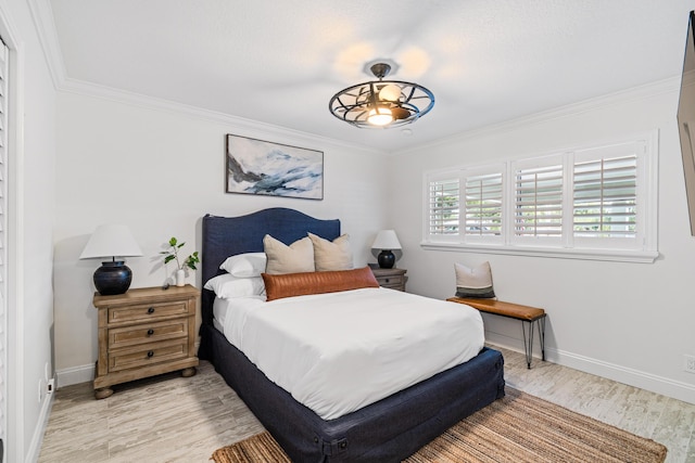 bedroom with baseboards, light wood finished floors, and ornamental molding