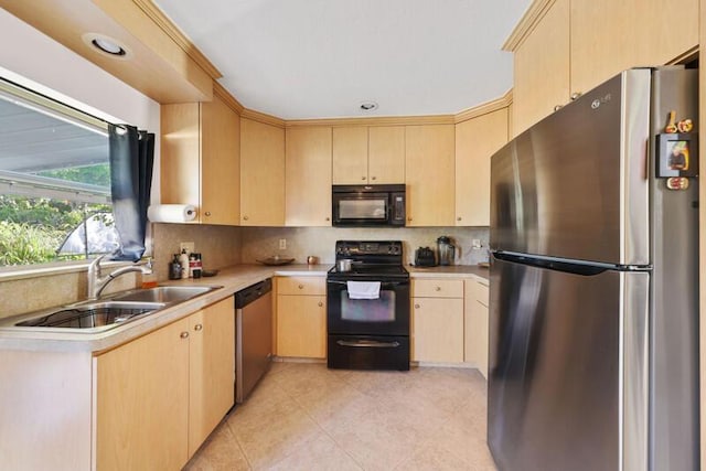 kitchen featuring a sink, black appliances, light brown cabinets, and light countertops