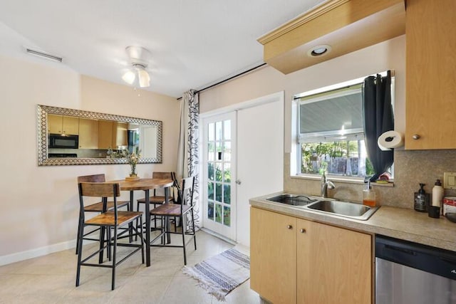 kitchen with visible vents, a sink, tasteful backsplash, black microwave, and dishwasher