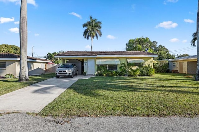 ranch-style home featuring a carport, stucco siding, driveway, and a front lawn