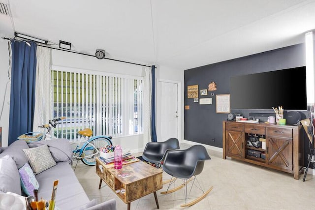 living room featuring tile patterned flooring and baseboards