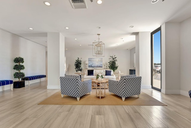 living area with visible vents, expansive windows, recessed lighting, light wood finished floors, and baseboards